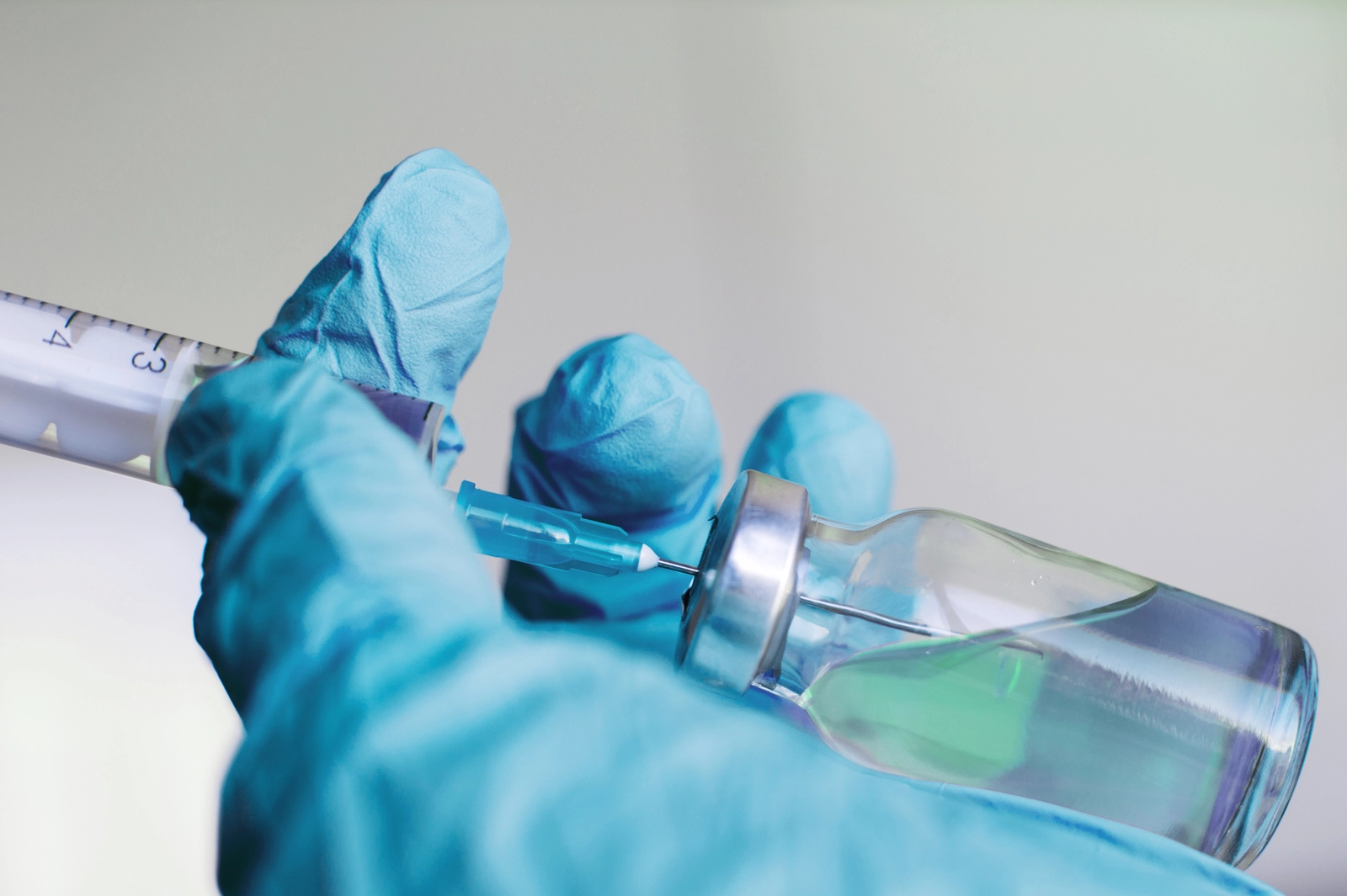 Can You Overdose on Ketamine? A hand in a blue glove filling a syringe with a clear liquid.